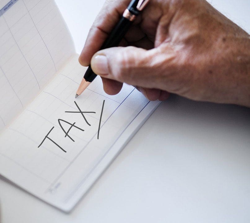 Tax penciled onto blank checkbook