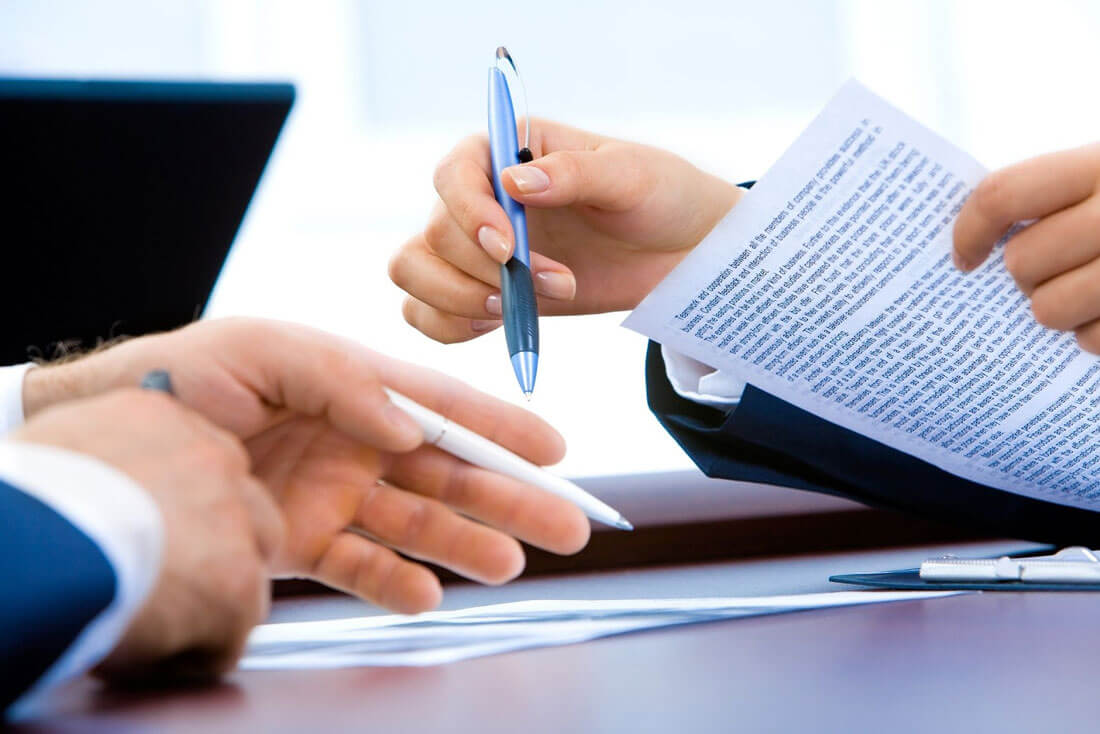 Attorney with client in meeting